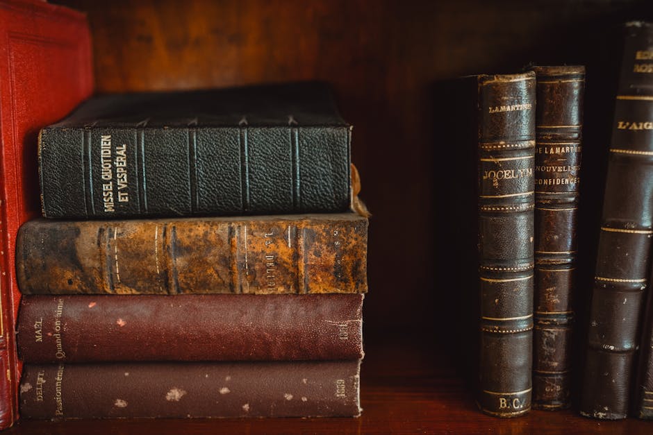 Estate planning attorney legacy context: a calm professional setting with a leather-bound book, a pen, and a thoughtfully arranged stack of estate planning documents on a polished desk, the kind of careful working environment where an estate planning attorney coordinates wills, trusts, powers of attorney, and beneficiary designations across a family's full asset picture