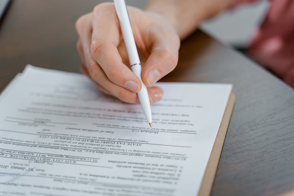 Estate planning attorney document set: a close-up of estate planning documents including a will, trust agreement, power of attorney, and advance directive arranged neatly on a wooden desk, the kind of organized package an estate planning attorney finalizes at the signing meeting after several rounds of family review