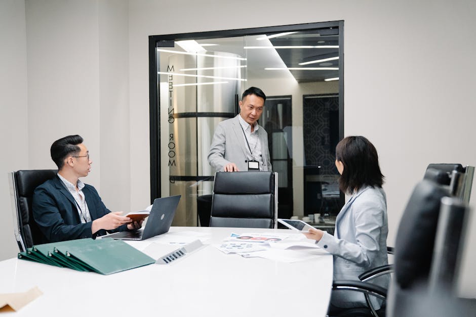 Child custody lawyer mediation prep: a calm professional conference room with a wooden table, neutral chairs, and a parenting-plan worksheet open on the table, the kind of measured working setting where a child custody lawyer prepares mediation positions and parenting-time proposals before a family-court conference