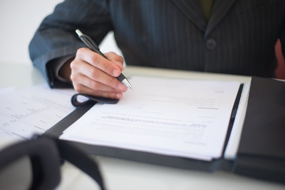 Child custody lawyer parenting-plan documentation: a close-up of a parenting-plan worksheet and family-law intake documents on a wooden desk with a pen, the kind of careful documentation a child custody lawyer reviews during the first 30 days of a contested or uncontested custody matter