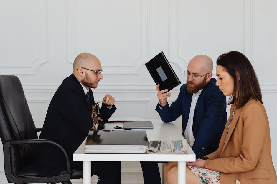 Personal injury attorney consultation: a calm professional office setting with a desk, legal documents, and two people across from each other reviewing a folder, the kind of first meeting where a personal injury attorney walks an injured person through the realistic timeline and process before any retainer is signed