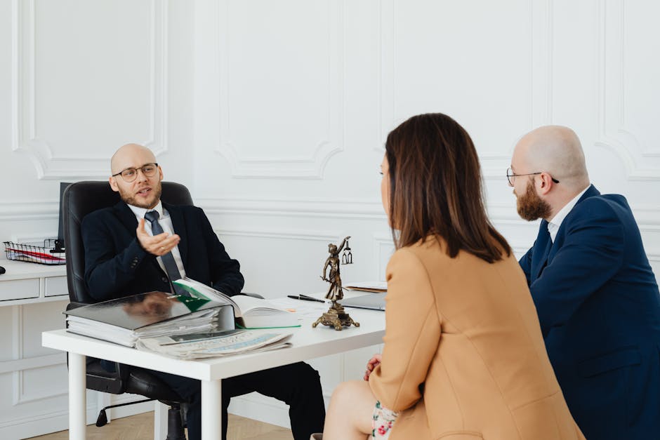 Child custody lawyer consultation context: a calm professional office with two people seated across a wooden desk reviewing family-law documents and a parenting plan template, the kind of careful first meeting where a child custody lawyer walks a parent through the realistic timeline and decision factors a state family court will apply