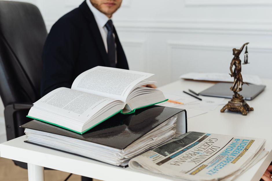 Open law books and an accident report on a desk illustrating what a search for a car accident lawyer near me actually involves