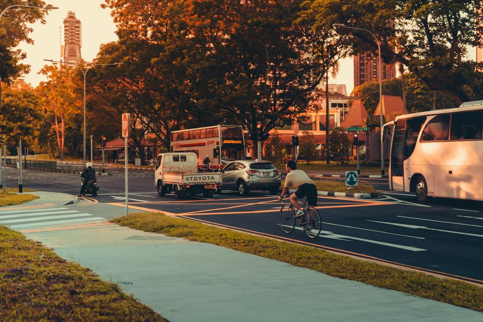 A cyclist riding on a road near vehicles, the kind of scene a bicycle accident lawyer reviews